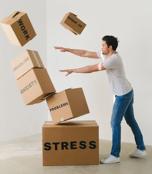 Man throwing away carton boxes with negative feelings written on them