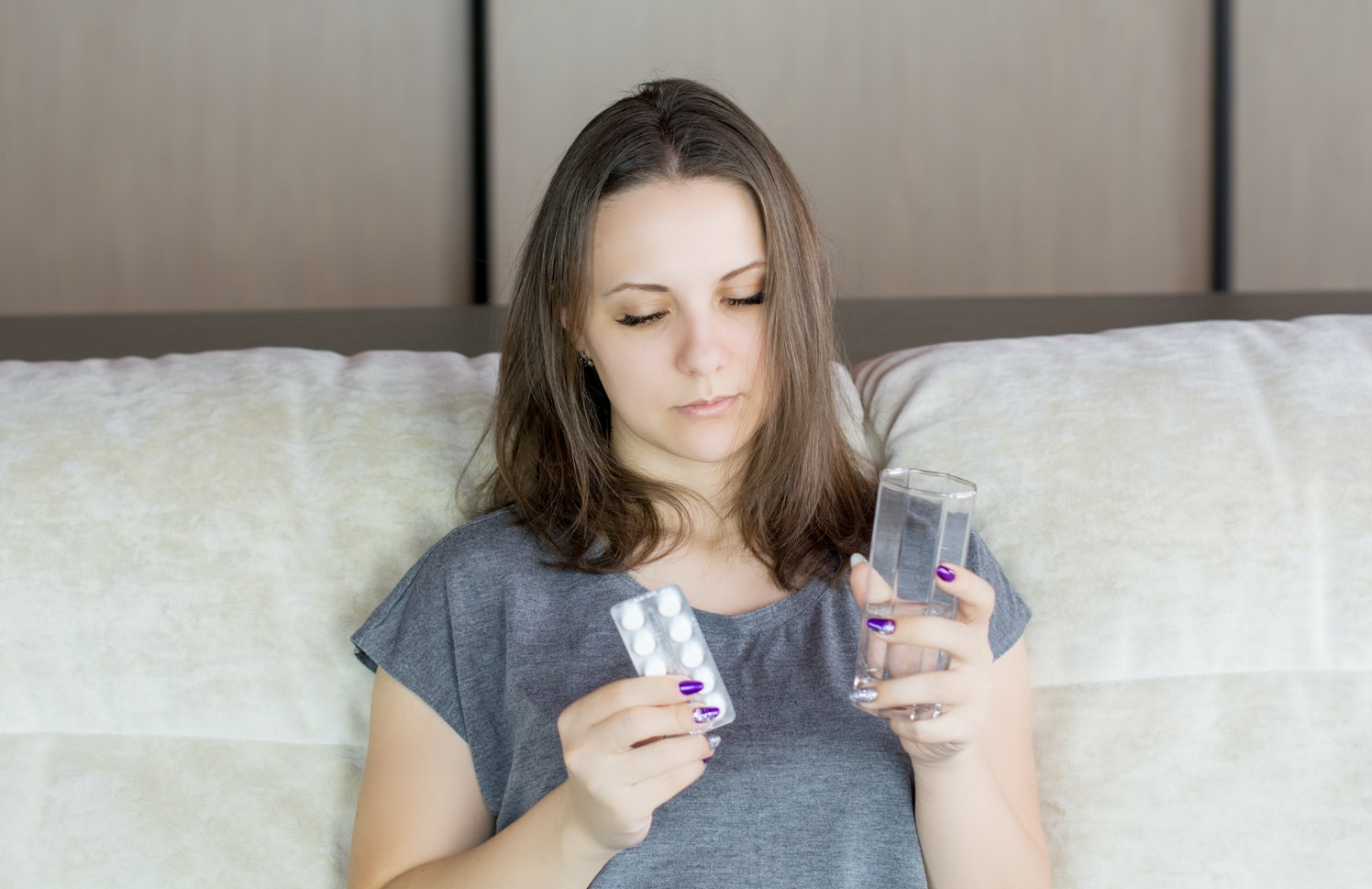 a sick woman taking medicine