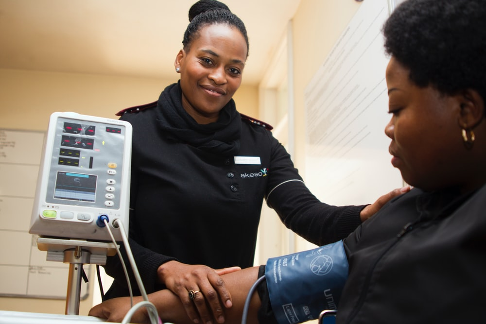 woman having her blood pressure monitored