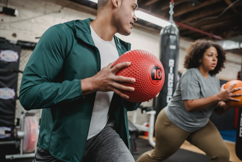 A woman doing exercise with an instructor