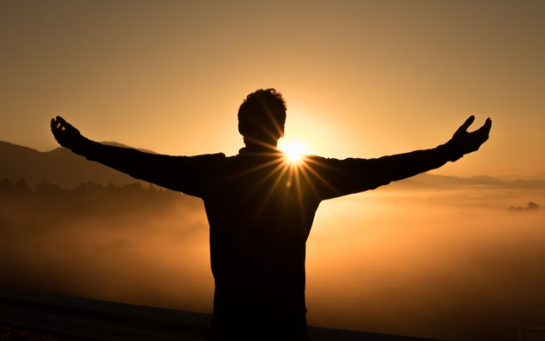 Silhouette of man against the sun.