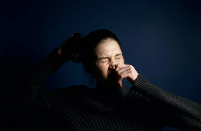 Woman about to sneeze.