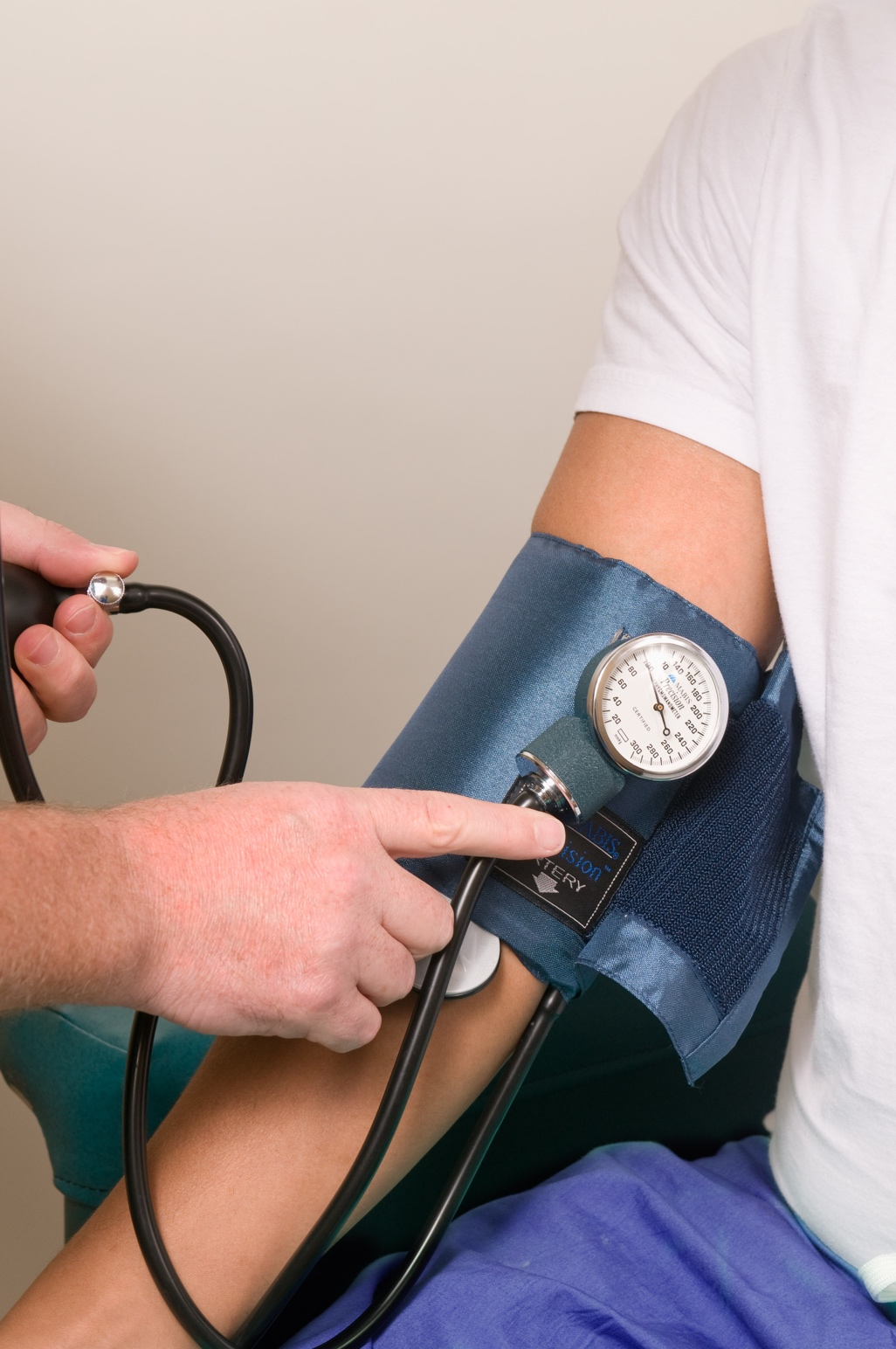 A doctor checking a patient’s blood pressure